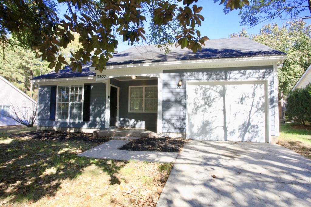a white house with a sidewalk in front of it