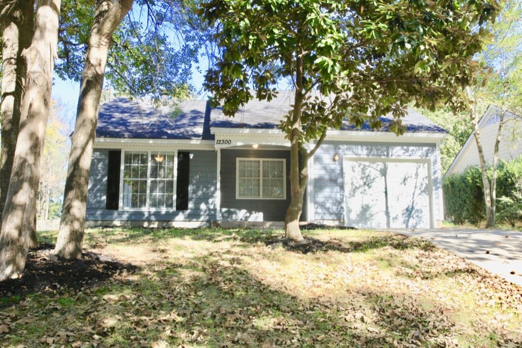 a blue house with trees in front of it