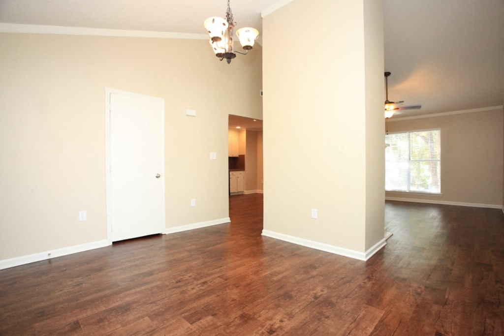 an empty living room with a hard wood floor