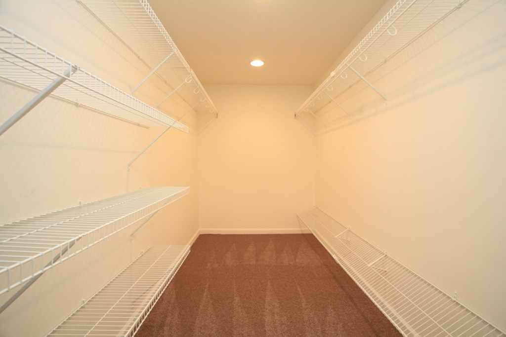 a bedroom with a closet and a window