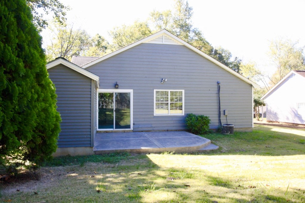 the front of the house with a concrete porch