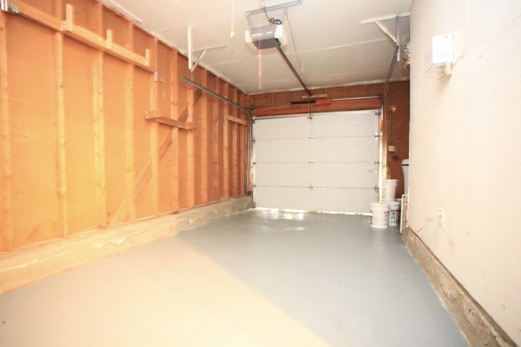 the inside of a garage with a white garage door