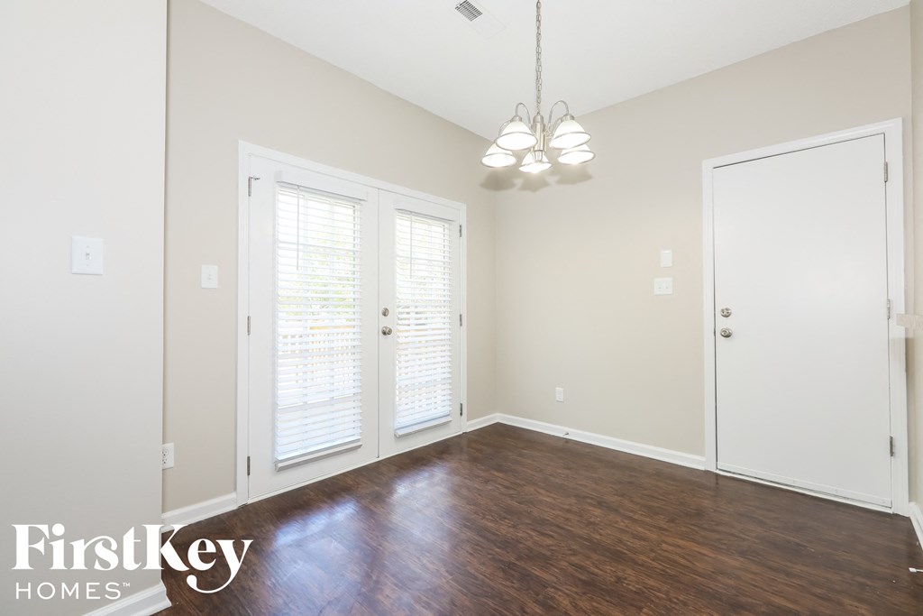 a living room with wood floors and white walls and white doors