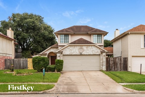 a house with a white garage door and a lawn