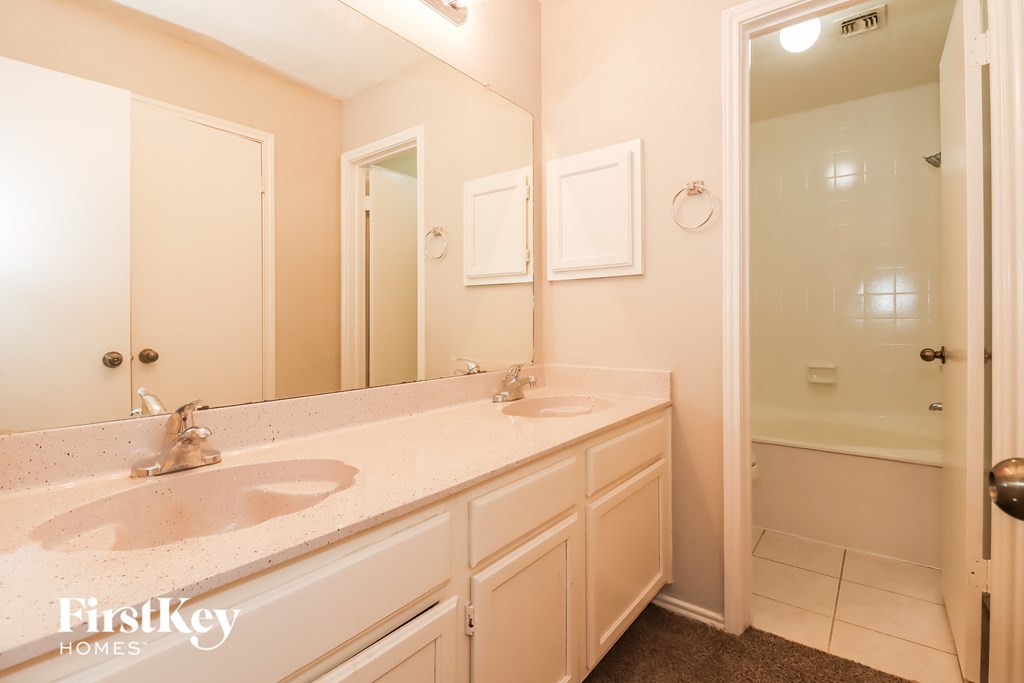 a bathroom with two sinks and a large mirror