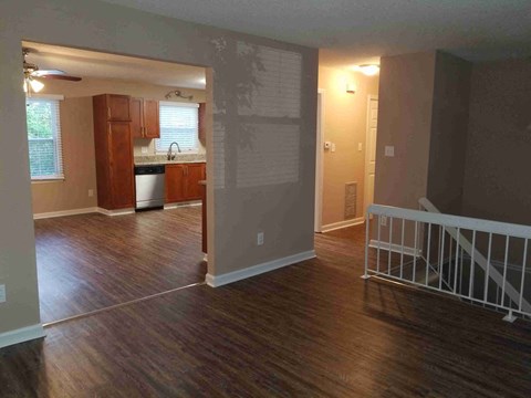 A kitchen with wooden floors and a white stove top oven.