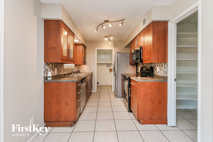 a kitchen with wooden cabinets and stainless steel appliances