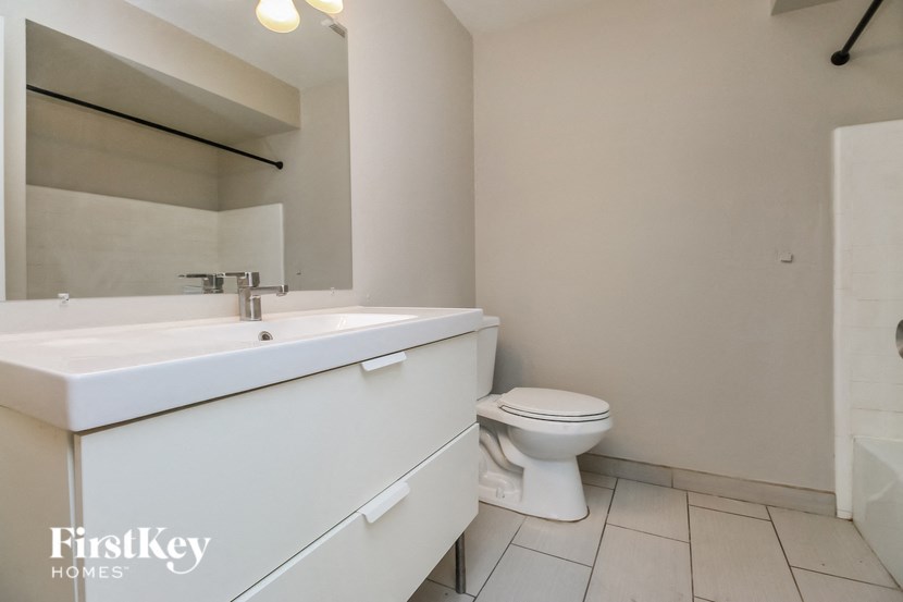 a bathroom with a sink and a toilet and a mirror