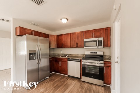a kitchen with stainless steel appliances and wooden cabinets
