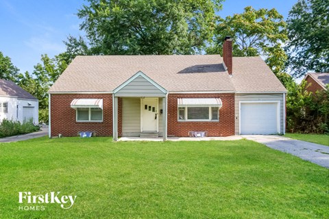A brick house with a white door and a chimney.