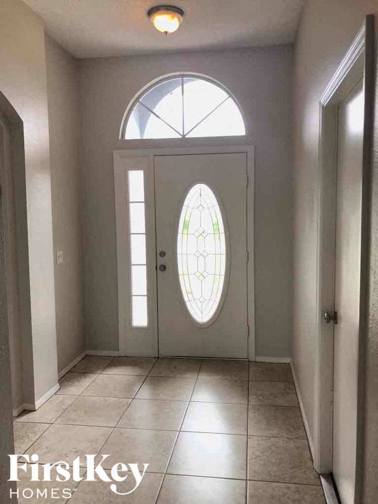 a view of a hallway with a door with a stained glass window