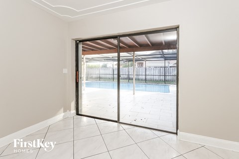 a sliding glass door leading to a swimming pool