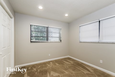 the living room is spacious and clean with a large window