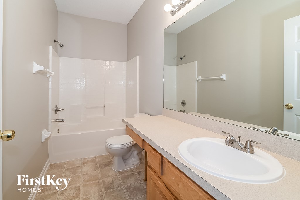 a bathroom with a sink and a toilet and a shower