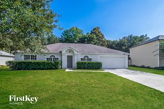 a white house with a lawn and a white garage door