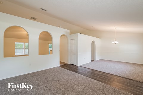 the living room and dining room with the entrance to the kitchen