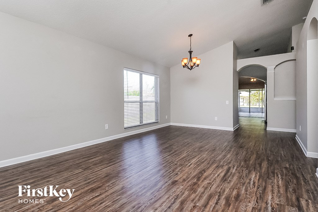 the living room and dining room with hardwood flooring