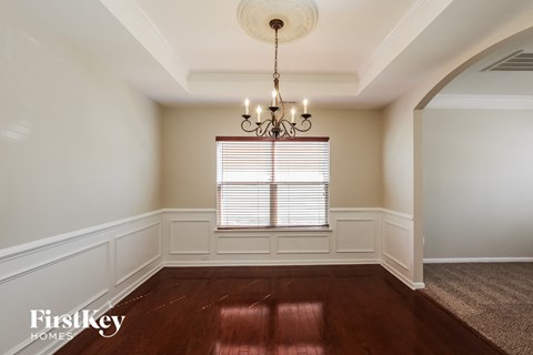 a dining room with a chandelier and a window