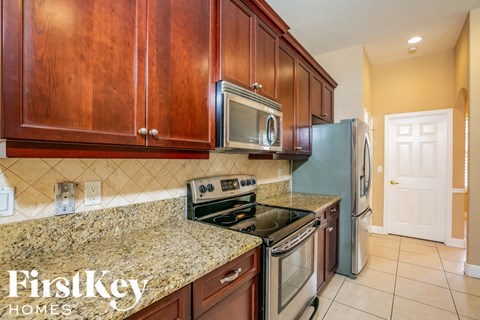 a kitchen with wood cabinets and stainless steel appliances and granite counter tops
