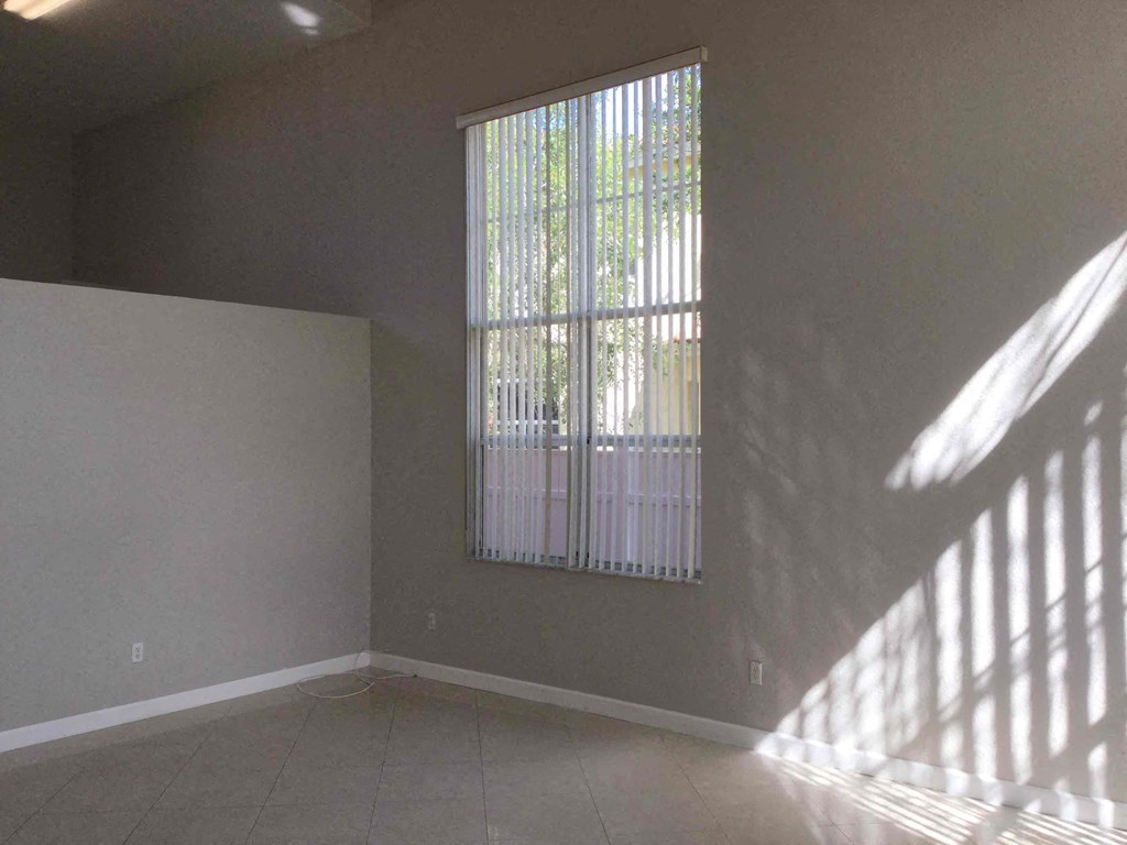 an empty living room with a large window