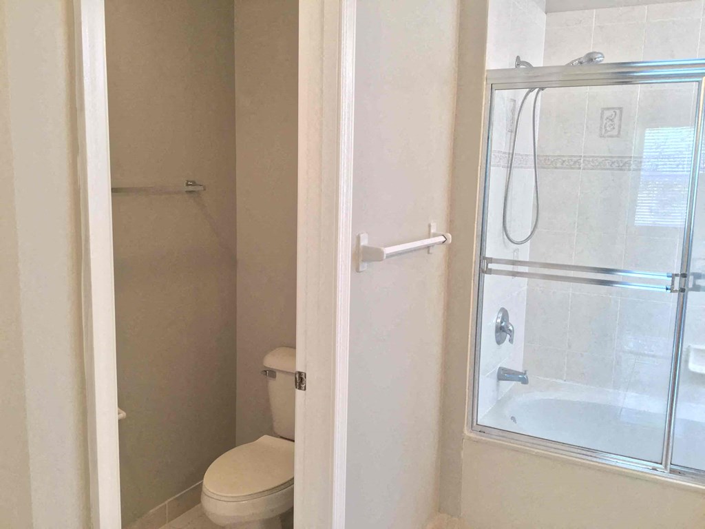 a small bathroom with a shower and a toilet