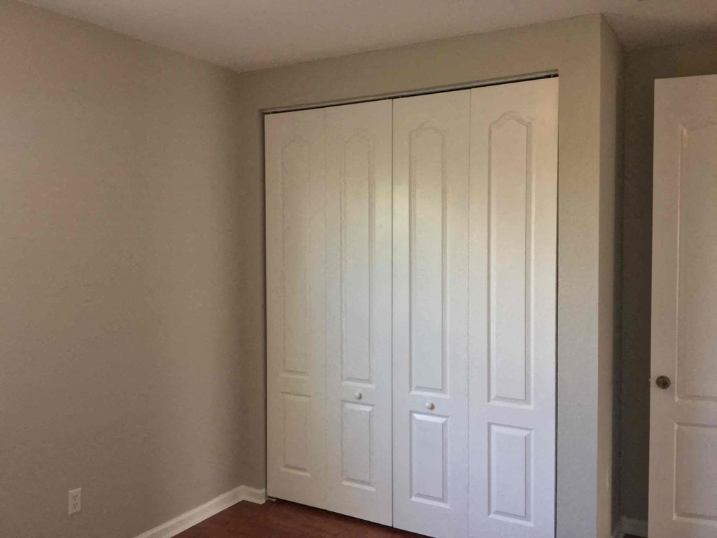 a pair of closets with white doors in a room