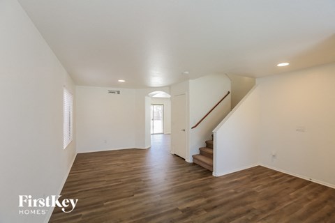 a renovated living room with white walls and wood floors