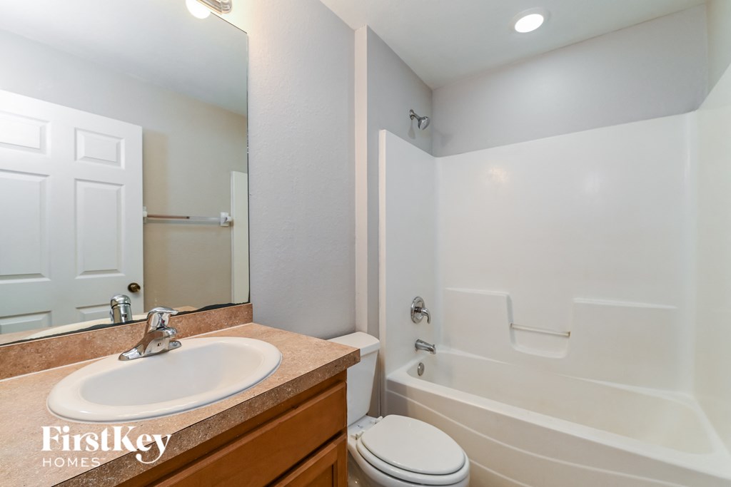 a bathroom with a sink and a toilet and a tub