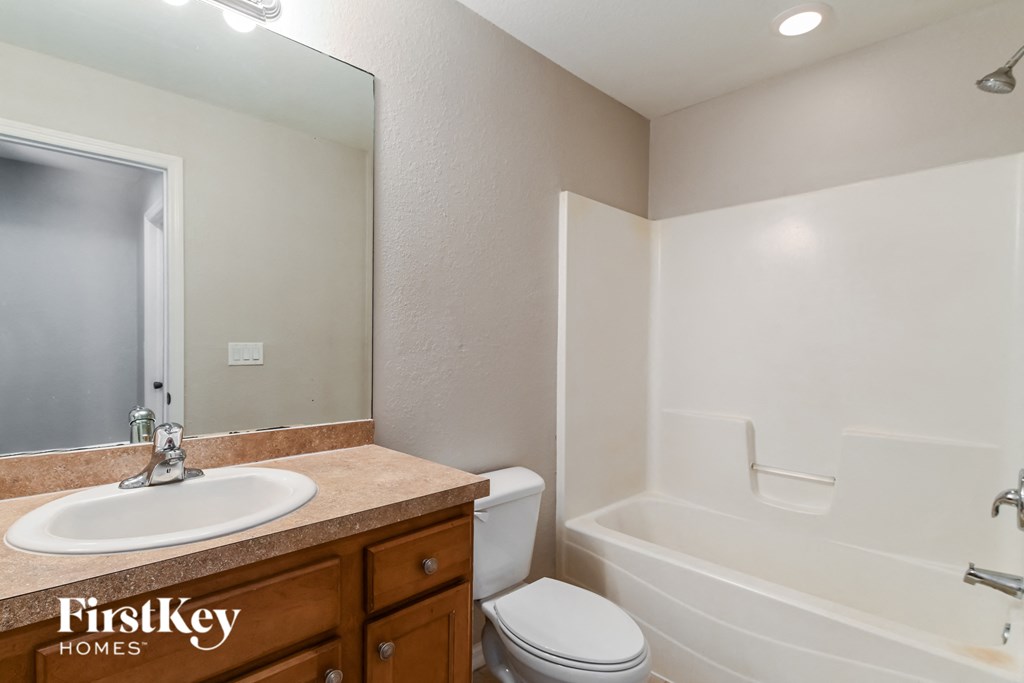 a bathroom with a sink toilet and a bath tub