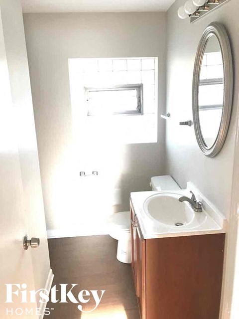 a small bathroom with a sink and toilet and a mirror
