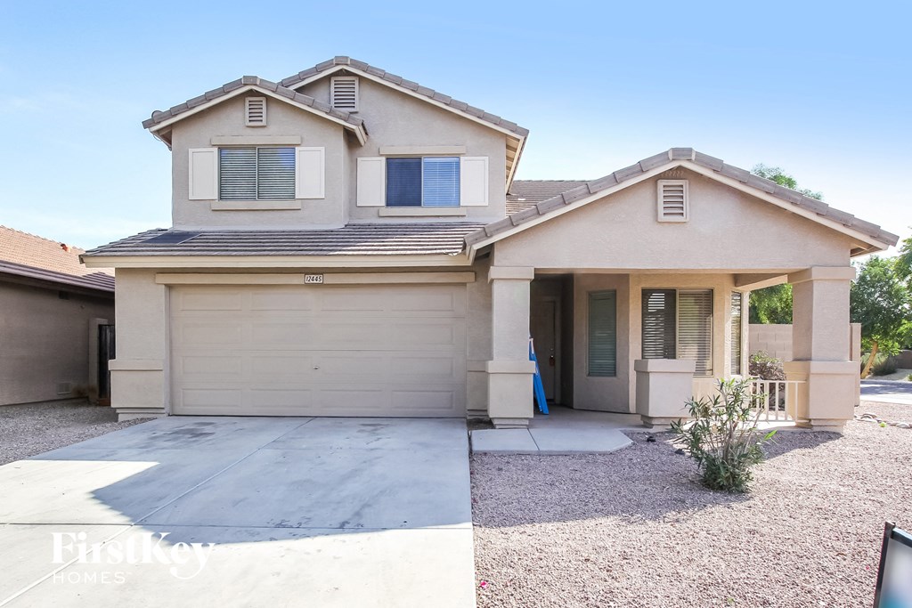 A two-story house with a garage is for sale.