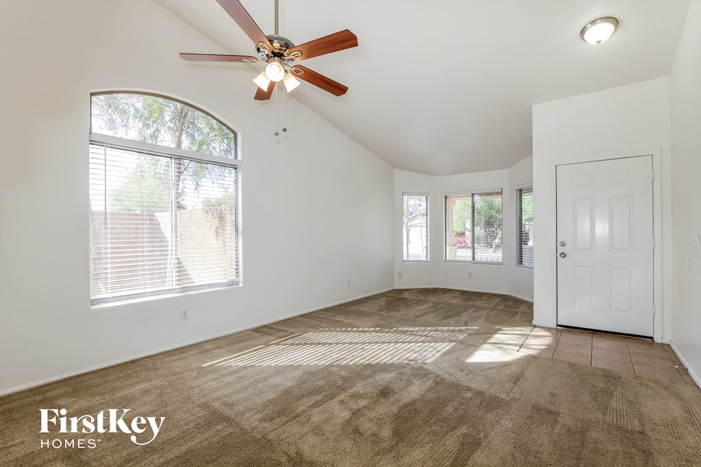 A room with a fan and a door is shown.