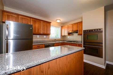 full view of kitchen with granite counter top and stainless steel appliances