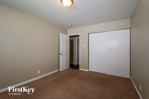a master bedroom with a closet and a door to the bathroom