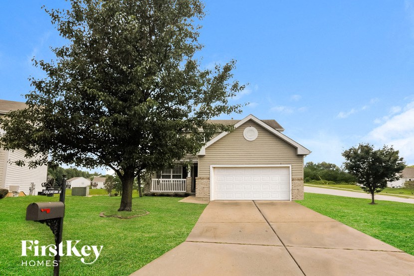a beige house with a white garage door