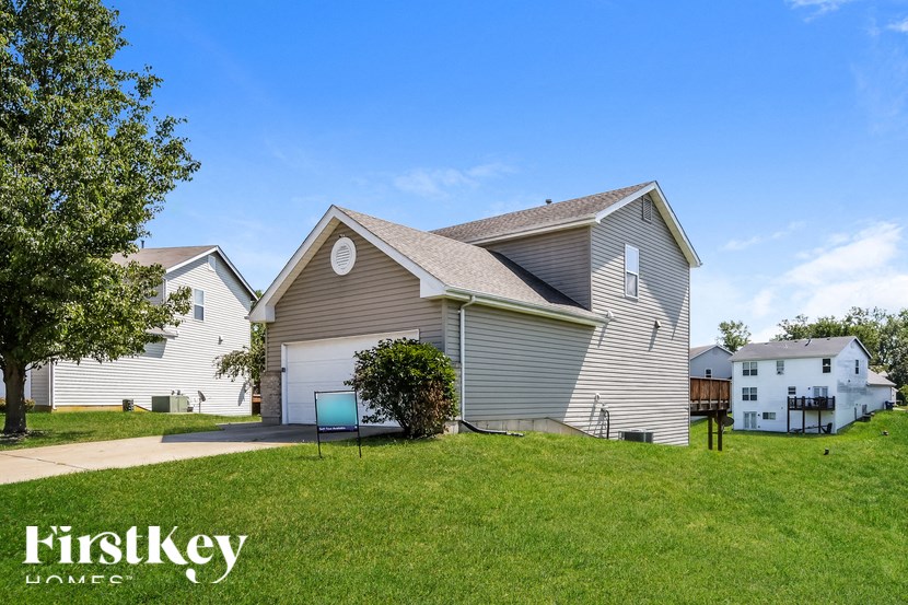 a house with a lawn and a driveway