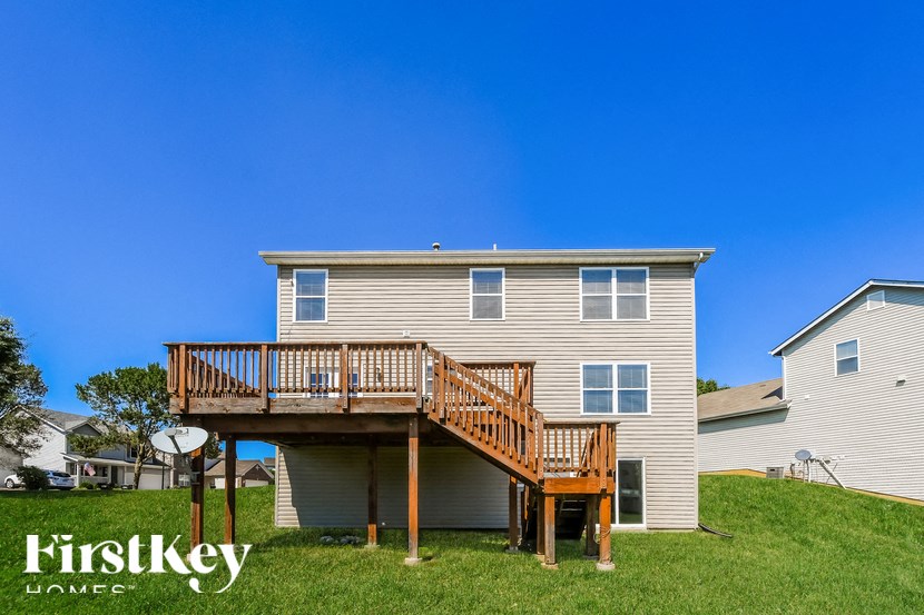 a house with a deck on top of a hill