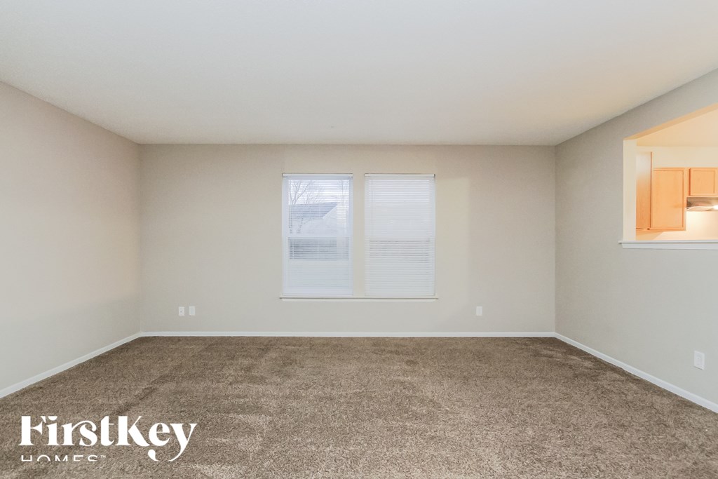 A carpeted room with a FirstKey Homes logo.