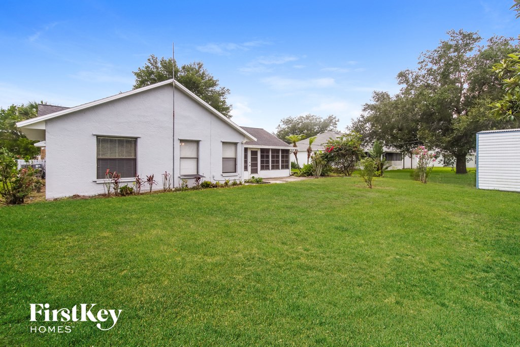 a white house with a yard in front of it