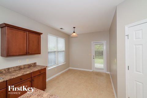 A kitchen area with wooden cabinets and a countertop.