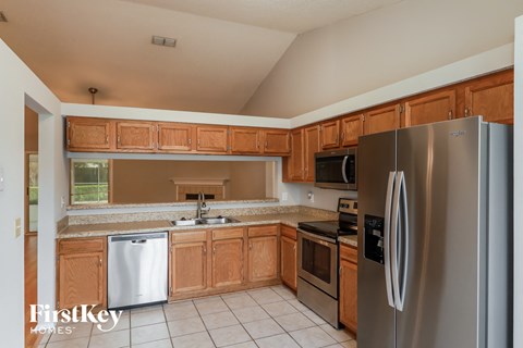 a kitchen with wooden cabinets and stainless steel appliances
