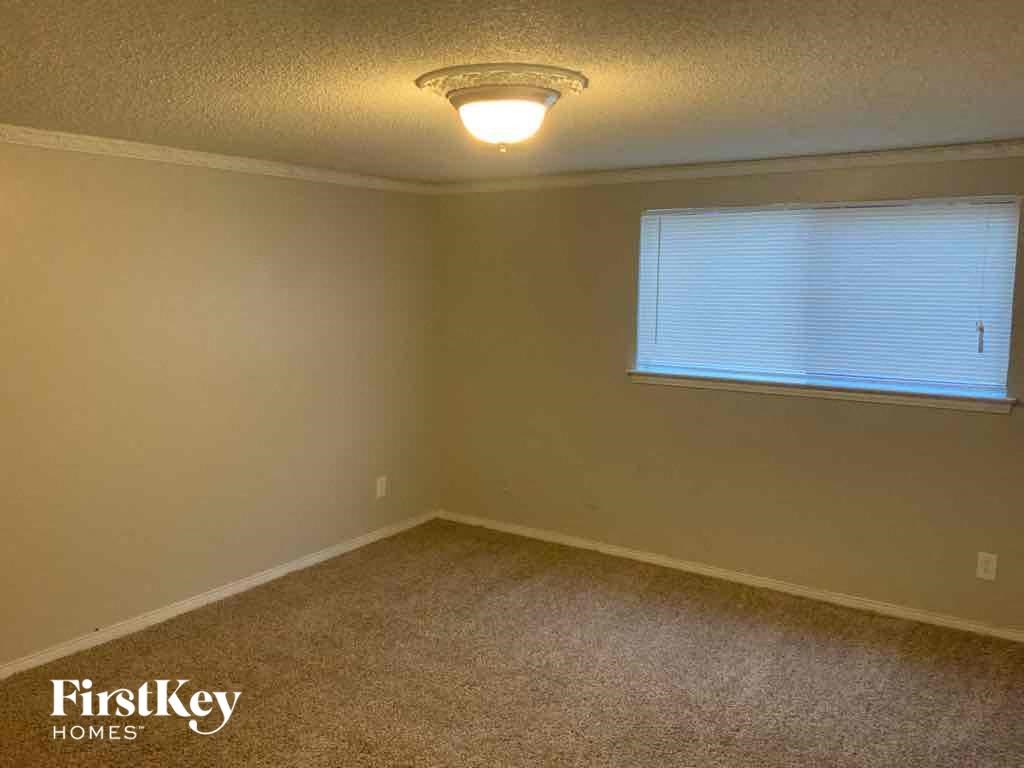 an empty room with a window and a light on the ceiling