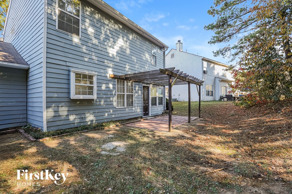 A house with a blue siding and a white roof is for sale.