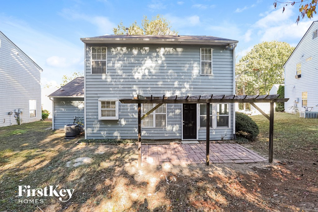 A house with a grey exterior and a covered patio area.