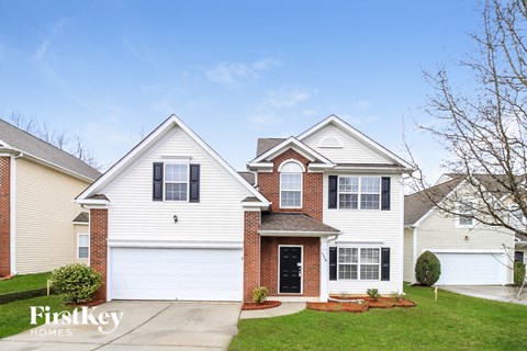 a white house with white siding and a black door