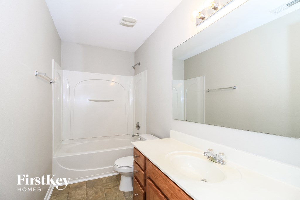a bathroom with a sink and a toilet and a shower