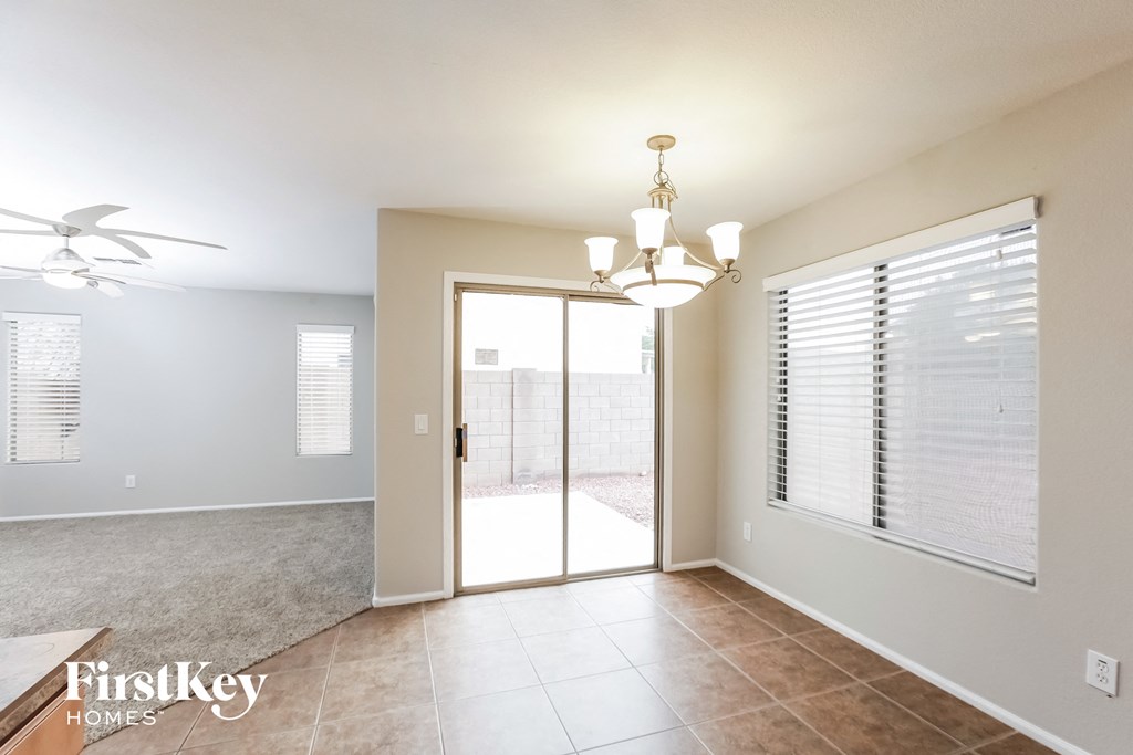 an empty living room with a sliding glass door to a patio