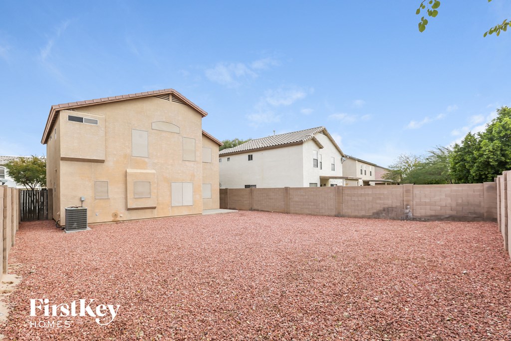 a house with a gravel driveway in front of it