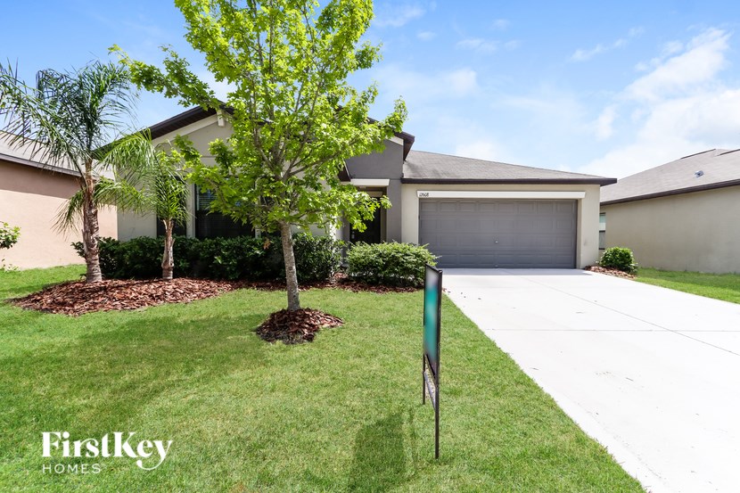 A house with a sign that says FirstKey Homes in front of it.