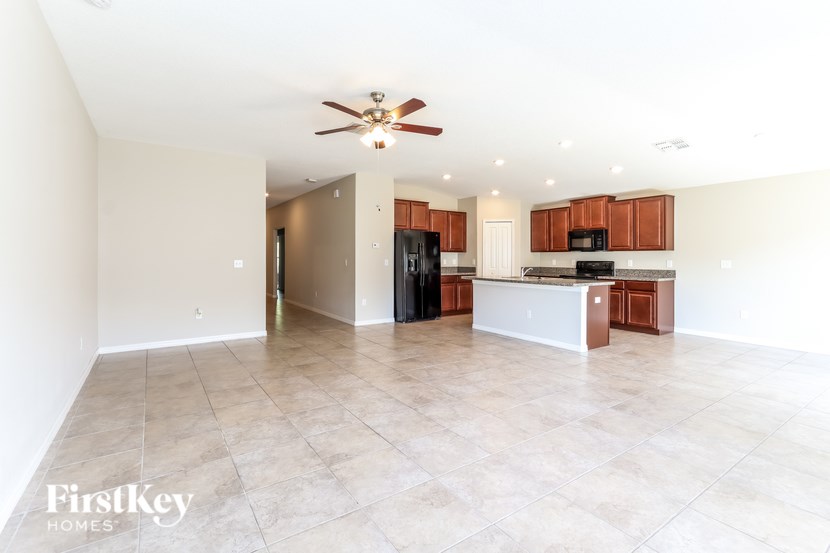 A spacious kitchen with a white countertop and brown cabinets.